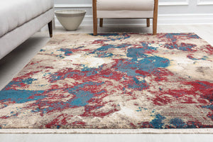 Modern abstract rug in red, blue, and beige hues, perfect for adding a contemporary touch to living room decor.