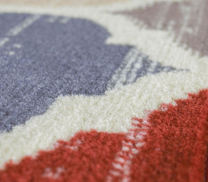 Close-up of the texture and detail of a colorful geometric patterned rug.