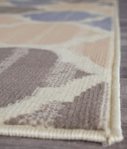 Close-up of abstract rug edge with beige, brown, and blue patterns. Ideal for modern home decor, showcasing detailed craftsmanship.