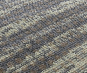 Detailed view of modern abstract rug pattern, showcasing soft fibers and intricate design in shades of brown, beige, and gray.