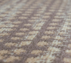 Close-up of modern abstract rug texture, highlighting intricate patterns and soft fibers in shades of brown and beige.