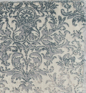 Close-up of blue and white floral area rug highlighting its intricate and elegant design.