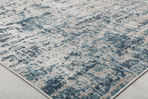 Close-up of a rug with a distressed blue and white pattern, highlighting its texture and contemporary design for modern interiors