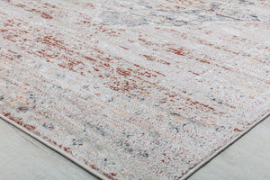 Corner view of vintage-style rug with distressed red and beige pattern, showcasing its intricate design and soft texture.