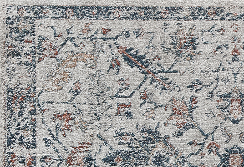 Close-up of vintage-style rug with intricate floral patterns in blue, beige, and rust, ideal for adding classic elegance to any room.