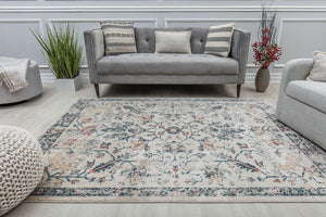 Vintage-style rug in a modern living room setting, featuring intricate floral patterns in blue, beige, and rust, adding classic charm to the decor.