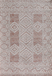 Overhead view of a red and white geometric pattern rug with intricate designs.