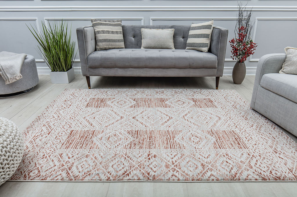 Modern living room with a gray sofa and a red and white geometric pattern rug.