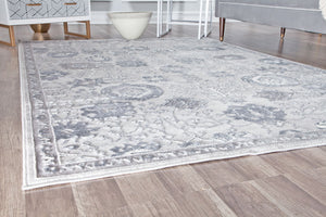 Gray area rug with floral patterns in a modern living room, enhancing the decor with its detailed design and soft texture.