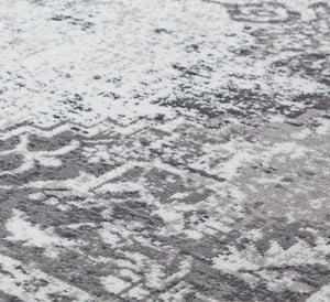 Detailed close-up of a gray and white vintage rug pattern, highlighting the intricate design and texture for a classic look.