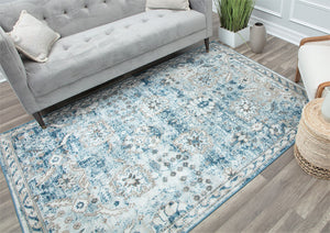 Elegant vintage-style rug with intricate blue and beige floral patterns in a modern living room, enhancing the decor with a classic touch.