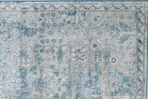 Detailed view of vintage-style rug with intricate blue and beige patterns, perfect for adding a classic touch to any room's decor.