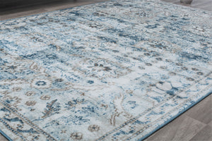 Elegant vintage-style rug with intricate blue and beige patterns, perfect for adding a touch of classic charm to any room's decor.