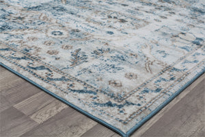 Corner view of vintage-style rug with intricate blue and beige patterns, enhancing the decor with a classic and elegant touch.