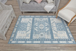 Stylish living room with a blue and beige geometric pattern rug, adding a touch of modern elegance and sophistication to the decor.