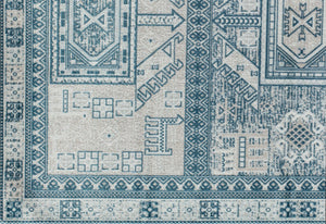 Close-up of a beige and blue geometric patterned rug, highlighting intricate design details and textures on the surface.