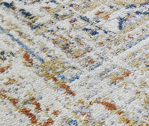 Close-up view of the detailed texture and colors of a Tuscan sun area rug.