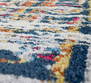 Close-up view of the texture and colors of a burnt sienna area rug.