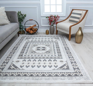 Elegant living room featuring a black and white patterned rug, cozy furniture, a log holder, and decorative vases with flowers