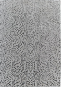 Top view of a white textured rug with a wave-like pattern.