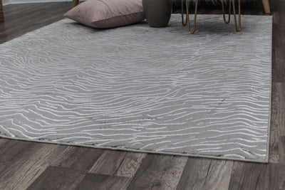 "Close-up of a white textured rug with a wave-like pattern in a modern living space.