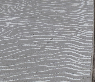 Top view of a white textured rug with wave-like patterns.