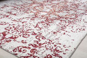 Close-up of a vintage-style rug with intricate red floral patterns on a beige background, ideal for adding elegance to any room