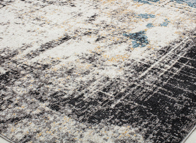 Detailed view of a rug with a distressed blue and beige pattern, emphasizing its texture and modern design for stylish interiors."
