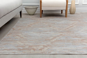 Close-up view of a minimalist beige area rug in a contemporary living room, showcasing its subtle texture and elegant design.