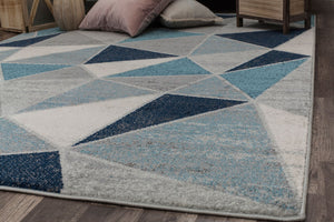 Side view of a geometric rug with blue and white triangles.