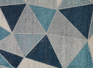 Detailed view of blue and white triangles on a geometric rug.