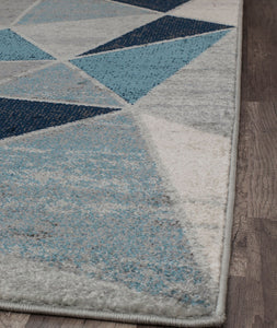 Side view of a blue and white geometric rug edge.