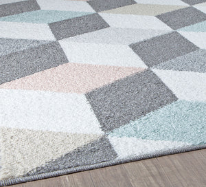 Close-up of geometric rug with 3D cube patterns in grey, pink, and blue, highlighting edge and design. Perfect for modern home decor.