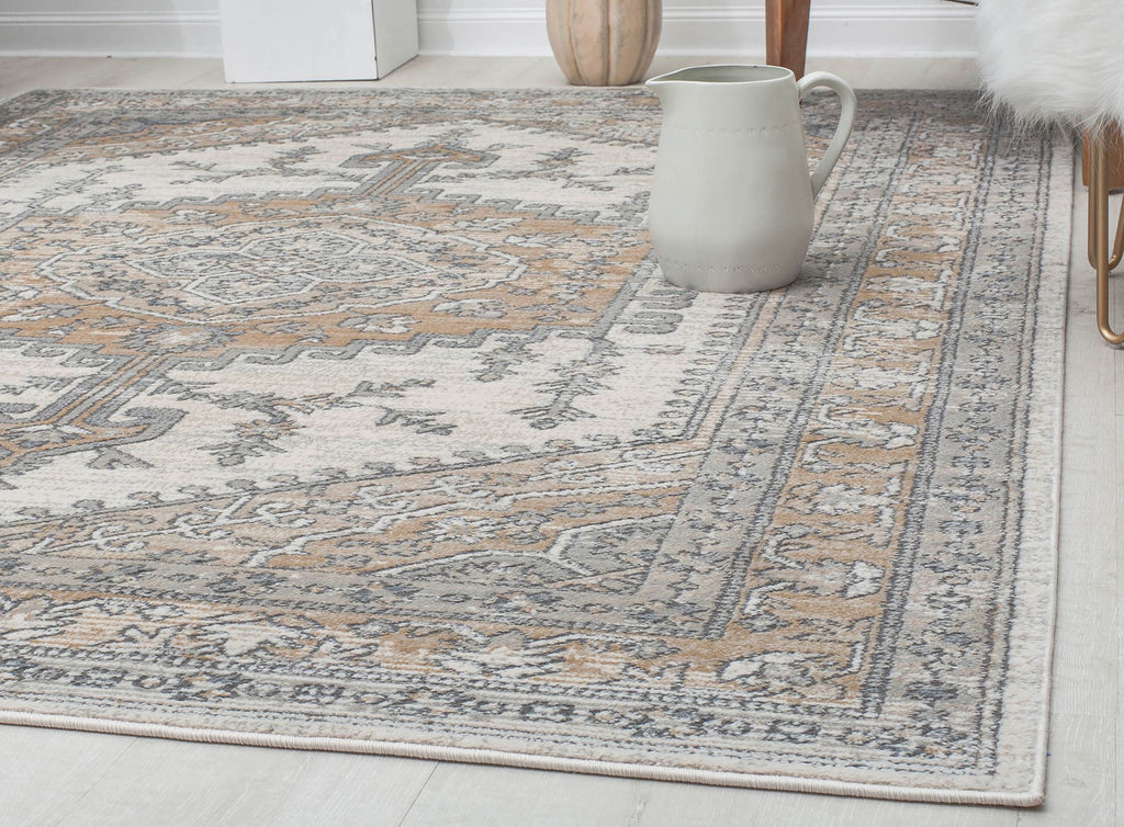 Close-up of an abstract beige and gray patterned rug in a modern living space.