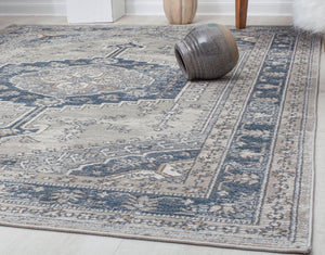 Detailed view of an abstract blue and beige rug in a contemporary living space.