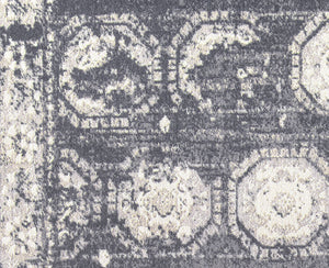 Close-up of the geometric design on a gray and white abstract rug.