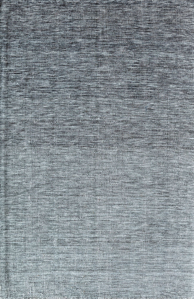 Close-up view of a gray area rug with a textured pattern.