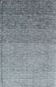 Close-up view of a gray area rug with a textured pattern.