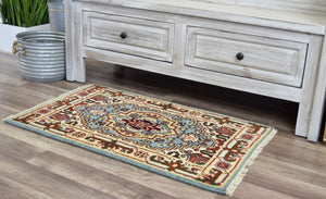 Small blue and red traditional area rug placed in front of a rustic cabinet.