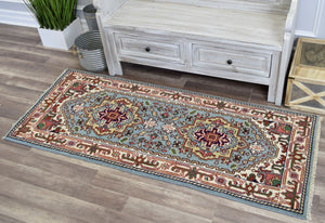 Blue and red traditional area rug placed in front of a rustic cabinet.