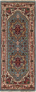 Top view of a blue and red traditional area rug with intricate patterns and designs.