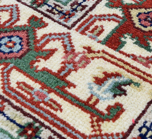 Detailed close-up of the patterns and textures on a traditional blue and red area rug.