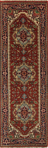 Top view of a narrow red and blue runner rug with intricate traditional patterns.