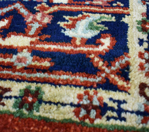 Close-up detail of the vibrant colors and intricate patterns on a traditional rug.