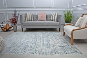 Stylish living room featuring a blue and gray geometric area rug, adding a modern touch to the decor.