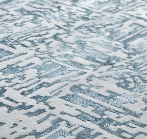 Close-up view of an abstract blue and white area rug."