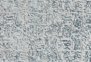 Detailed pattern of a blue and white abstract area rug.