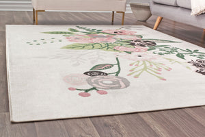 Close-up of a floral rug with green leaves and pink flowers on a cream background, perfect for adding a fresh look to any room.