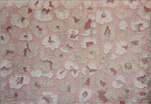 Top view of a pink and beige floral patterned rug with abstract flower designs.