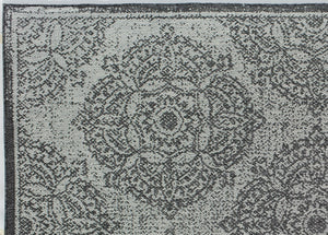 Detailed view of an abstract area rug showcasing complex floral patterns.